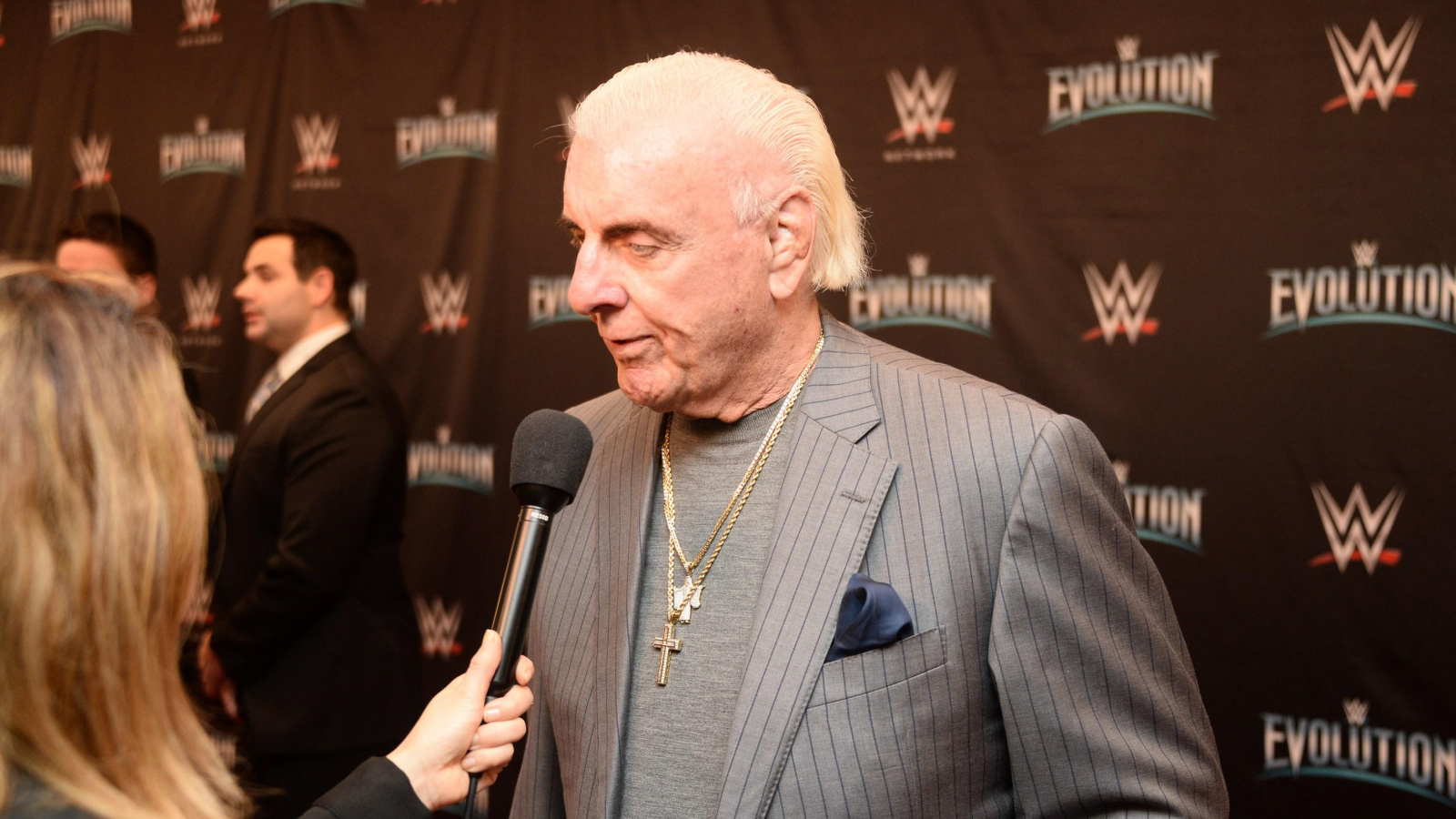 Ric Flair wearing a suit at a WWE media event